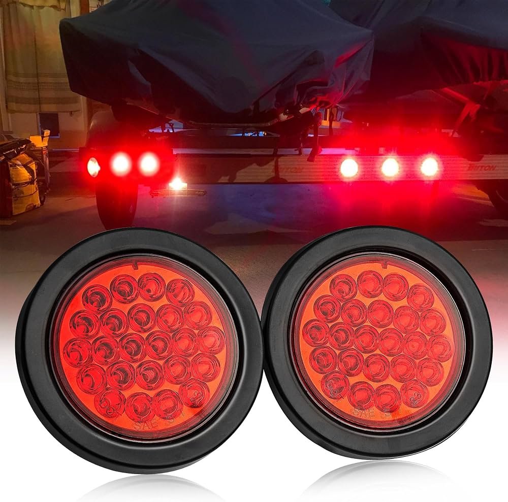 4-inch round sealed LED stop turn tail lights with red lens and black grommet mount, installed on a trailer at night